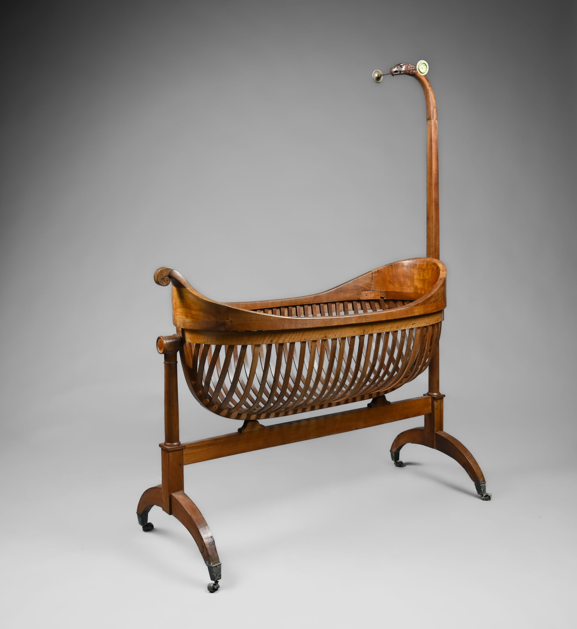 Walnut cradle, with fixed openwork nacelle, eagle-heade... | Beds: bids