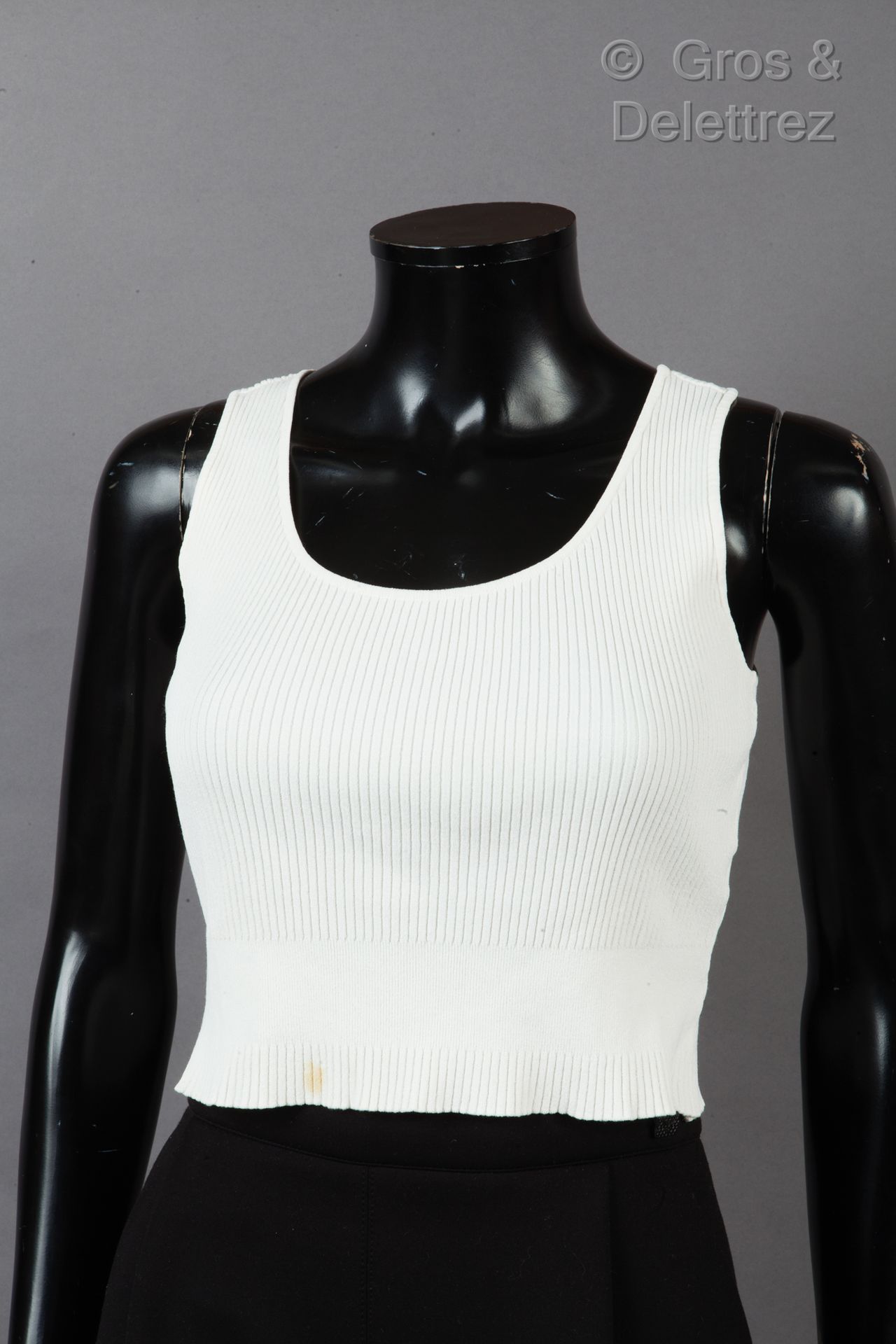 CHANEL Sleeveless cropped top in ecru ribbed knit, round neckline. White label, &hellip;