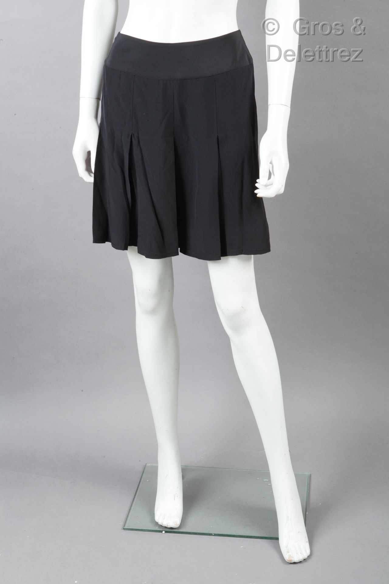 CHANEL 黑色丝质绉绸迷你裙，有平褶。黑色的爪子，白色的图形。