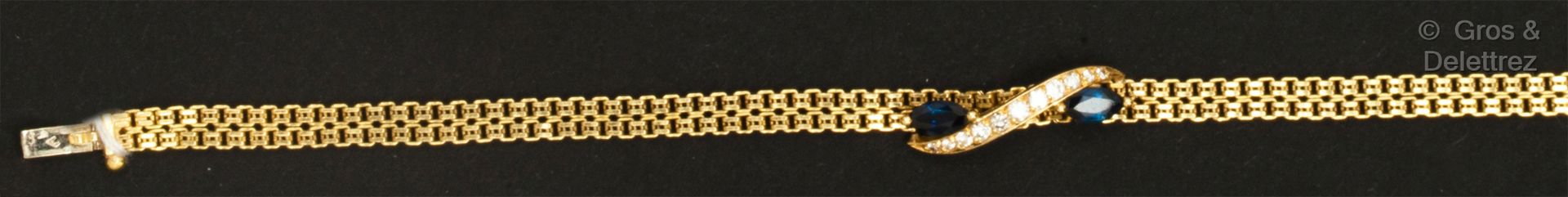 Null 灵活的黄金手镯，镶有一排明亮式切割钻石衬托的脐带蓝宝石图案。长度：6.5厘米。毛重：9.6克。