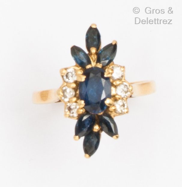 Null 黄金 "花 "戒指，在一圈脐带蓝宝石和明亮式切割钻石中镶嵌一颗椭圆形蓝宝石。手指大小：52。毛重：3.9克。