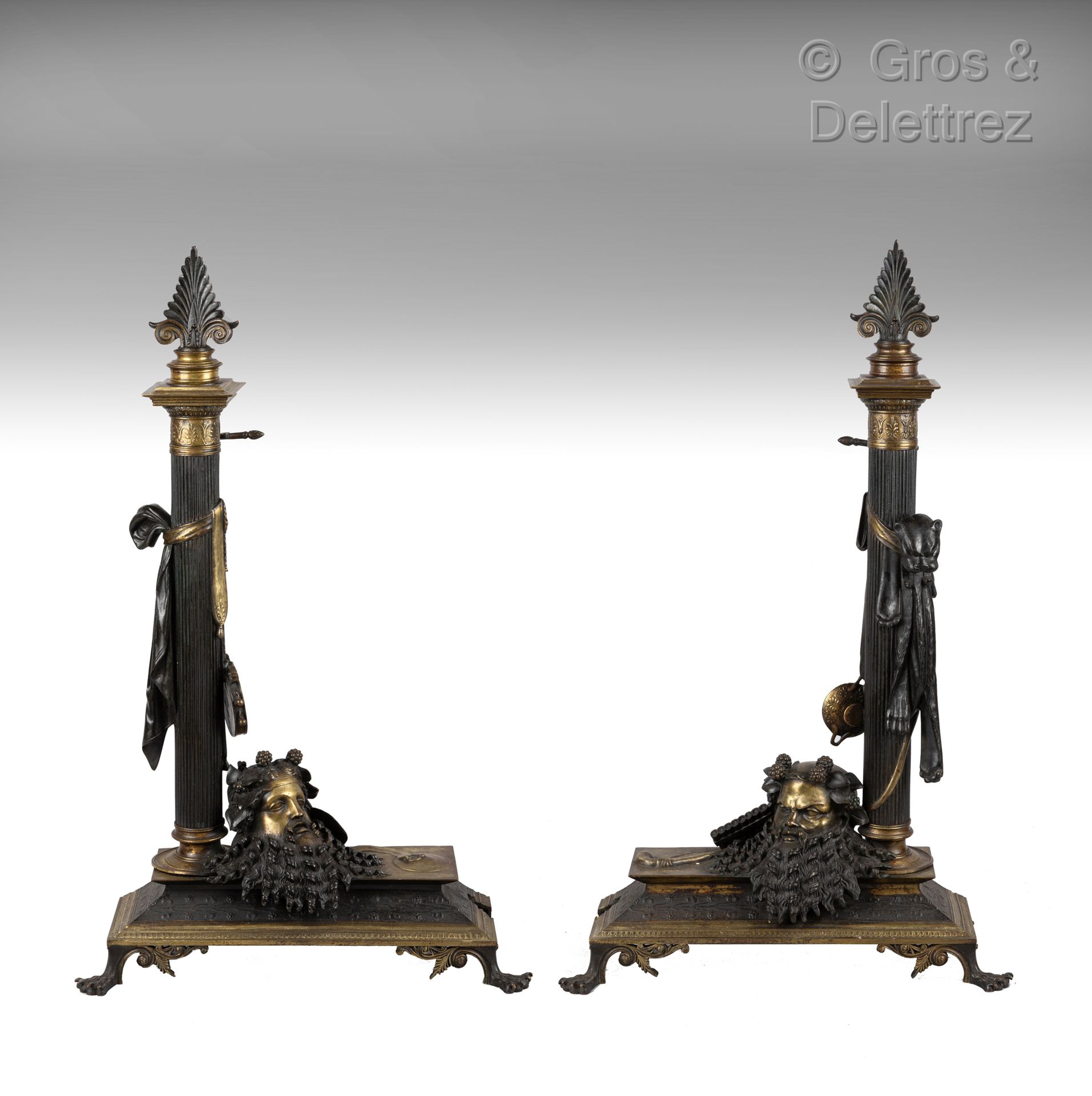 Null A pair of patinated bronze and gilt bronze andirons in the shape of a flute&hellip;