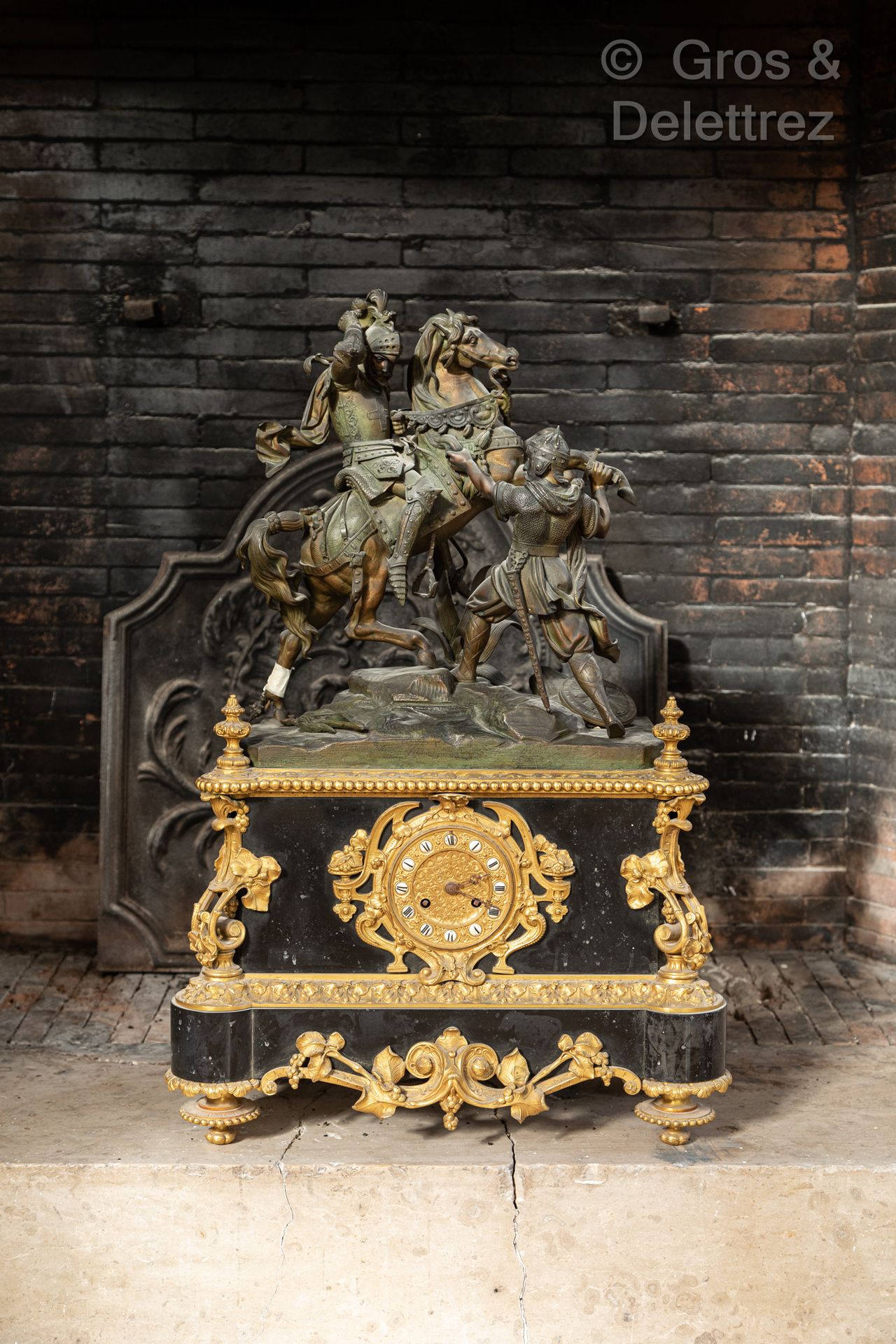 Null Gilded brass and black marble clock, surmounted by a group in regula repres&hellip;