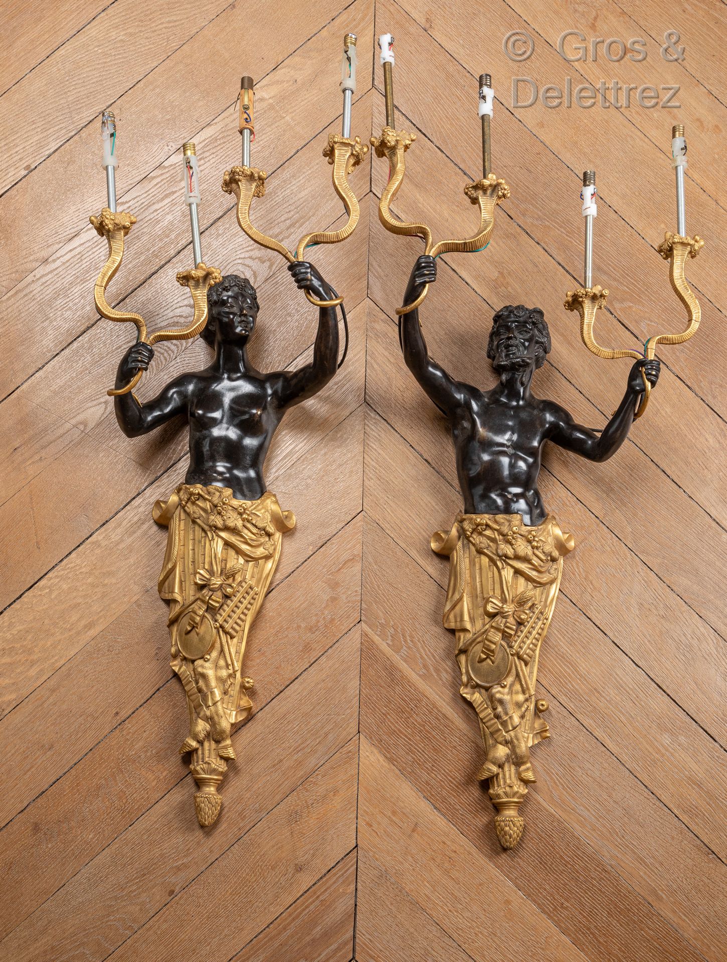 Null Pair of sconces in gilt bronze and black patina representing a bust of faun&hellip;