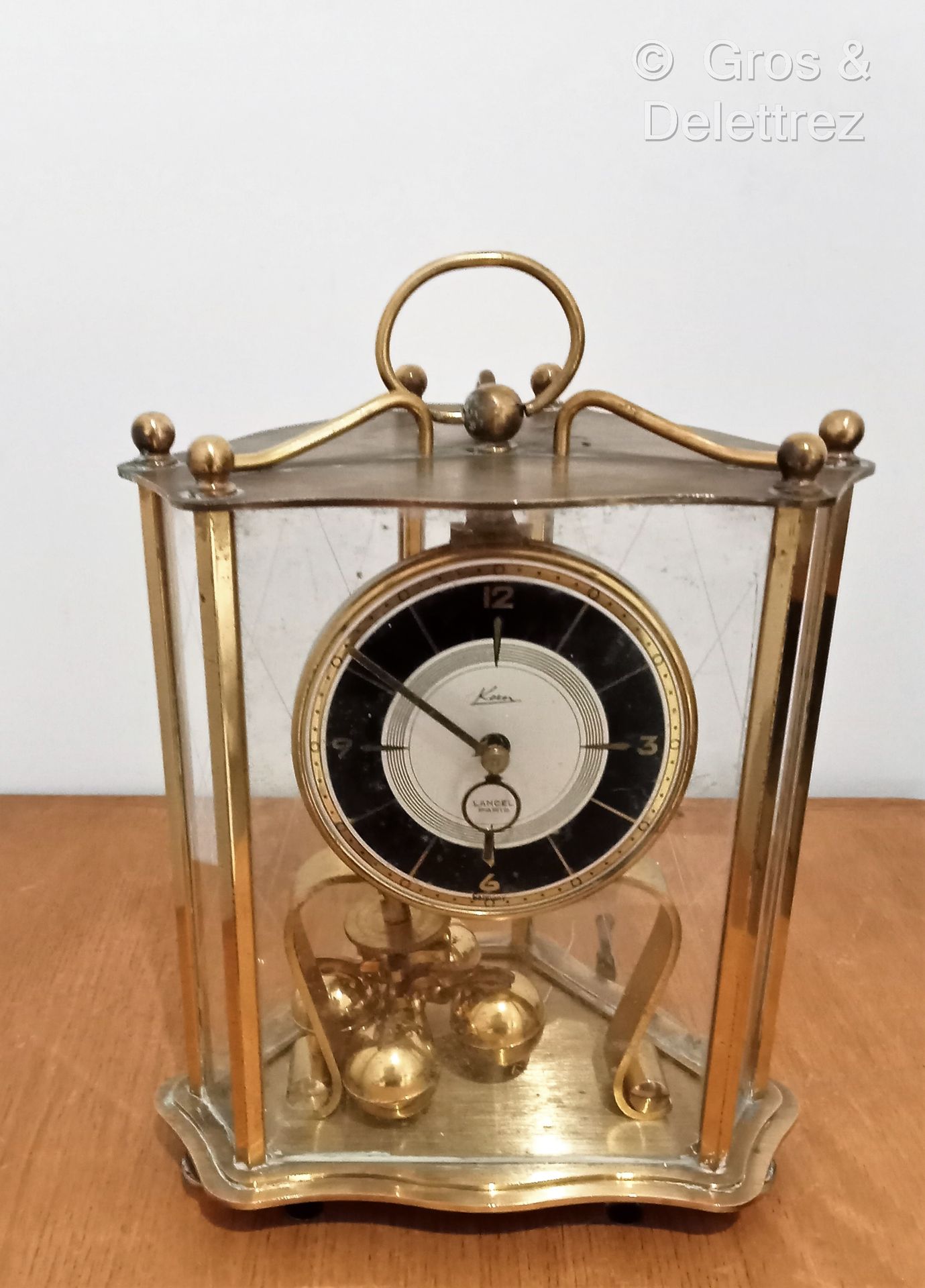 Null (E) LANCEL PARIS 

Gilt brass clock with cut sides, the dial enamelled blac&hellip;