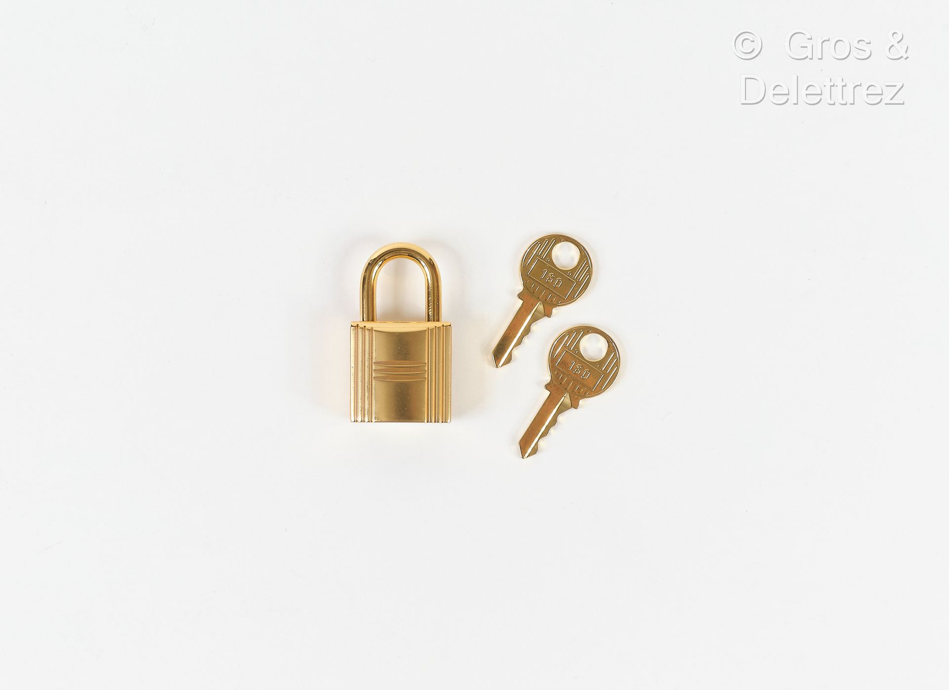 Null HERMES - Padlock in gilded metal and its two keys.
