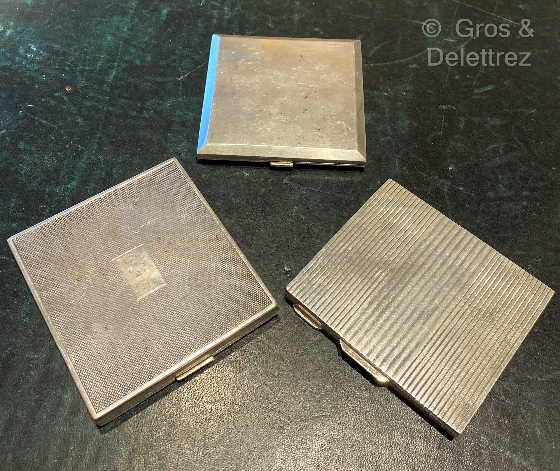 Null (E) Three silver and silver metal cigarette cases, one plain, the second gr&hellip;