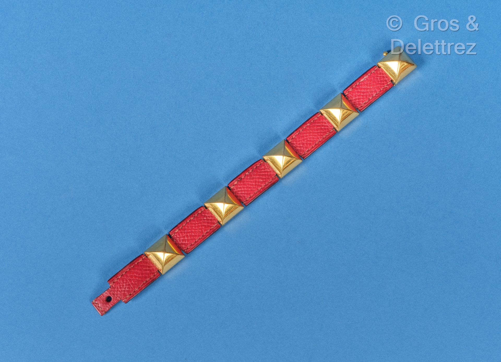Null HERMES Paris - "Clou" bracelet in gilt metal, interspersed with red Courche&hellip;