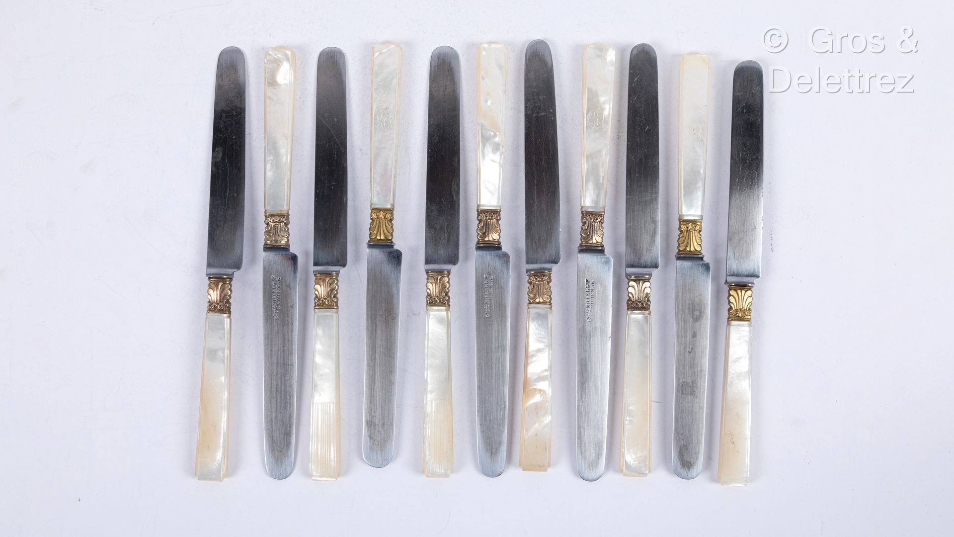 Null 11把珍珠母柄刀，其中两把略有不同，有条纹装饰，编号为CL，鎏金金属叶柄，钢制刀片，一些有米歇尔-维维安画廊的签名。 
19世纪中期。一个缺口