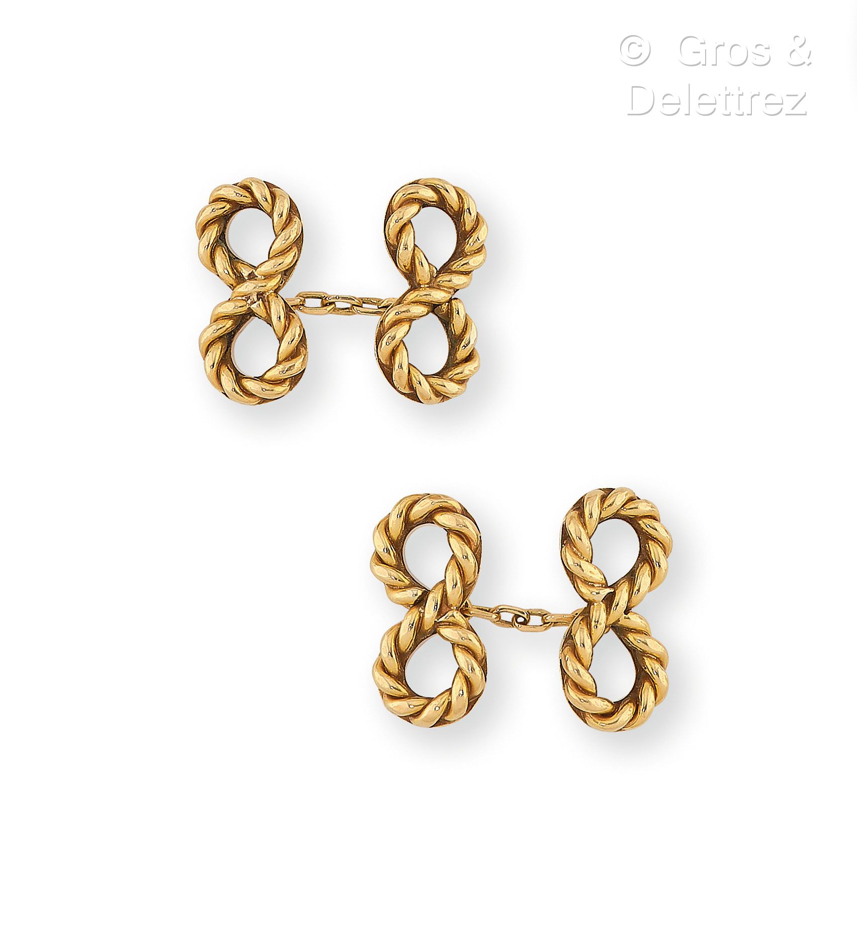 Null 卡地亚，1950年代 - 750千分之一黄金袖扣一对，末端饰有扭曲的无限符号。签名为 "卡地亚"，编号为 "08447"。图案的尺寸：2.1x1cm。&hellip;