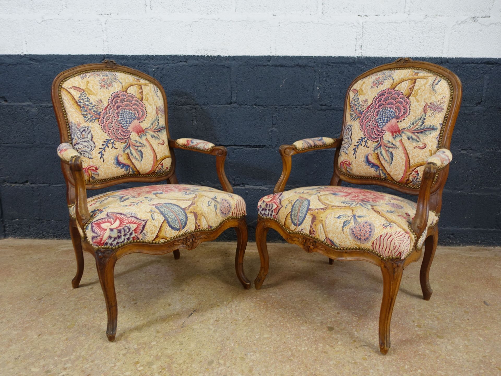 Null Pair of Louis XV period walnut armchairs, molded and carved with flowers, f&hellip;