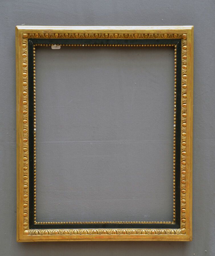 Null Frame in molded wood, carved, blackened and gilded, decorated with frieze o&hellip;