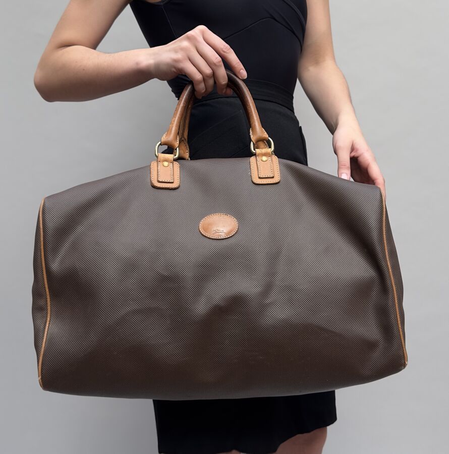 Null LONGCHAMP PARIS
Petit sac de weekend en toile cirée brune et cuir fauve.
44&hellip;