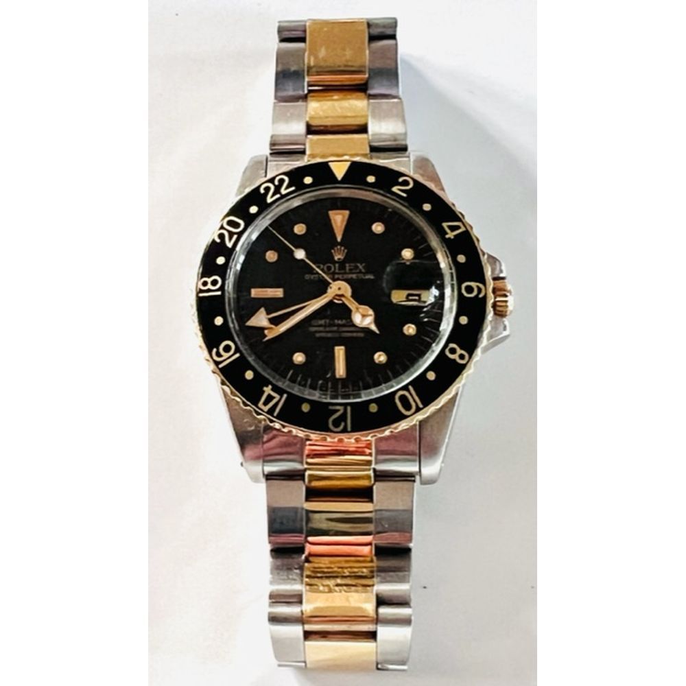 Null ROLEX. WATCH in steel and yellow gold 750°/°°. Model GMT Master Rootbeer. R&hellip;