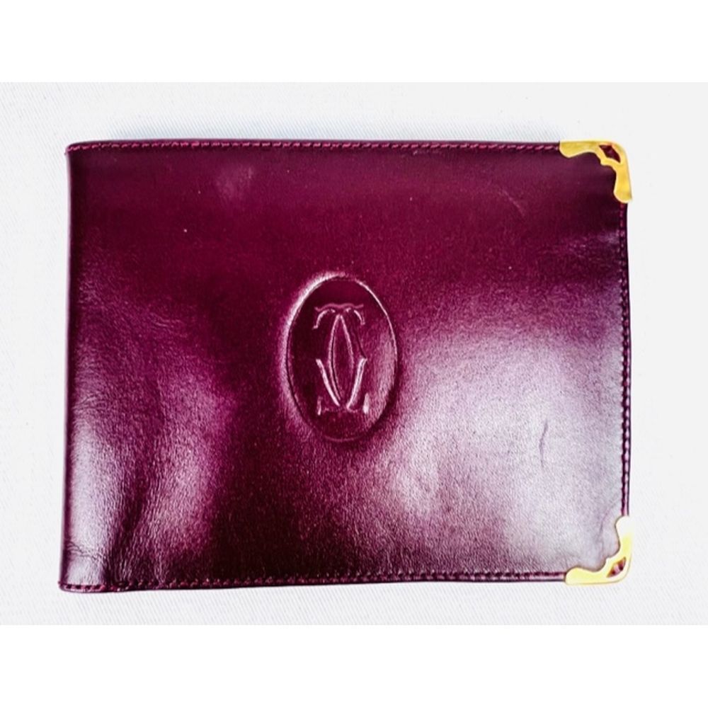 Null CARTIER. Card holder. Burgundy leather wallet. Good condition.