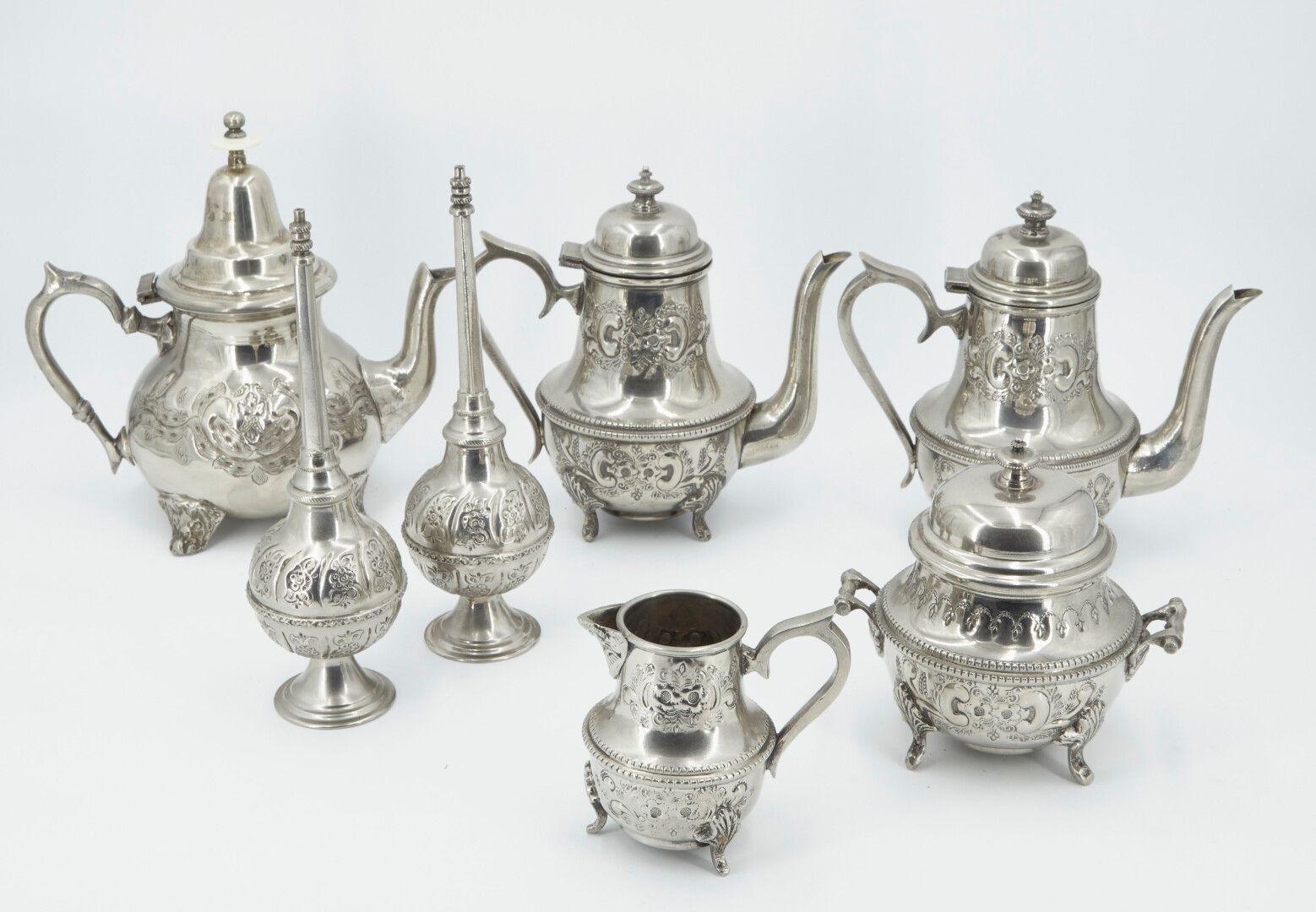 Null Chased and stamped metal tea set including:

- three teapots

- a milk jug
&hellip;