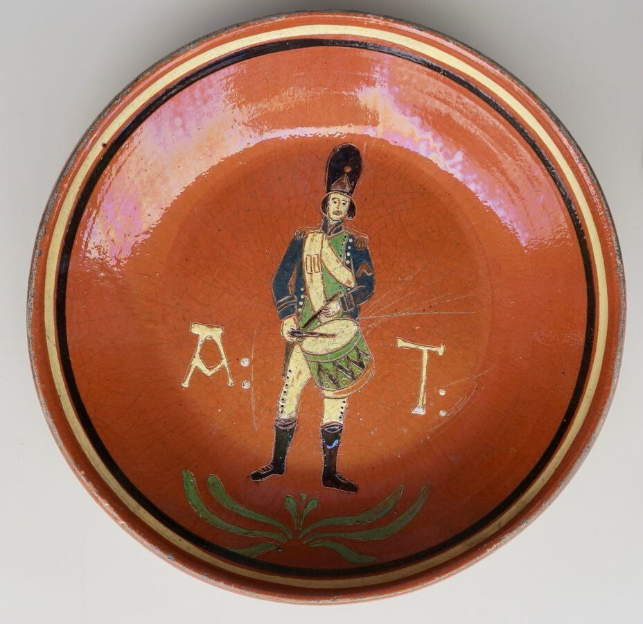 Null 表现第一帝国的士兵鼓手的釉面陶器，上面有首字母A T，直径37厘米。法国东部，19世纪。