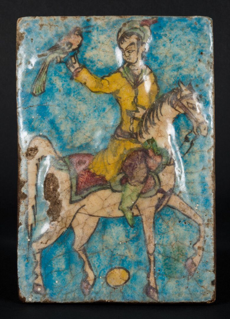 Null Persian glazed tile 

decorated with rider and falconer 

13 x 18.5 cm acci&hellip;