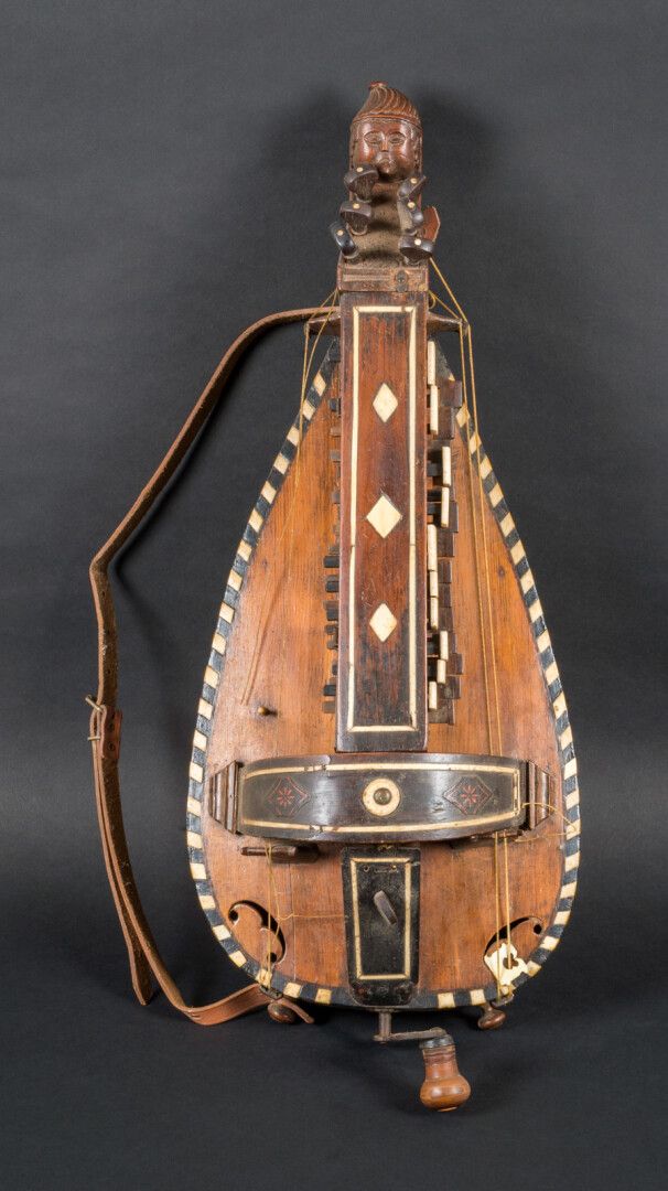 Null 
Hurdy-gurdy of popular manufacture, the handle showing a child's face with&hellip;