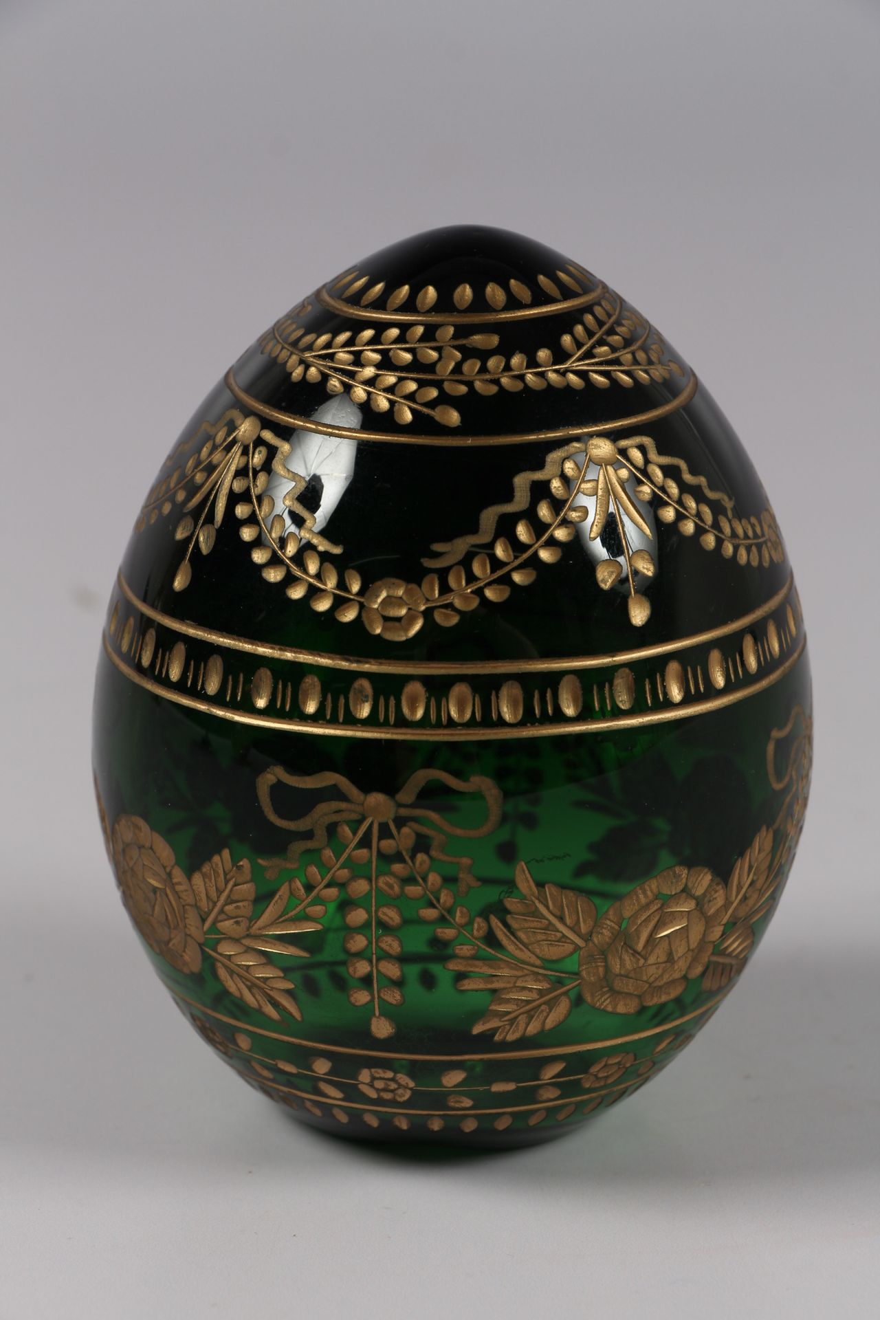 Null FABERGE. Egg in green tinted glass with engraved decoration heightened with&hellip;