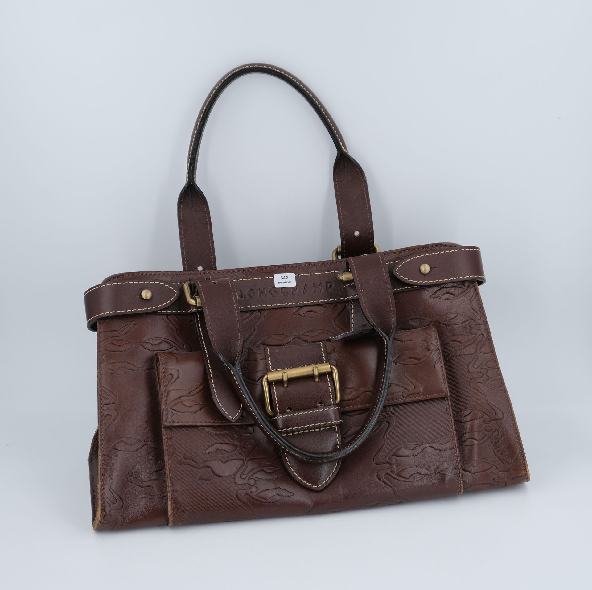 Null LONGCHAMP. Brown leather handbag monogrammed in relief. 22 X 35 X 13 (wear)&hellip;