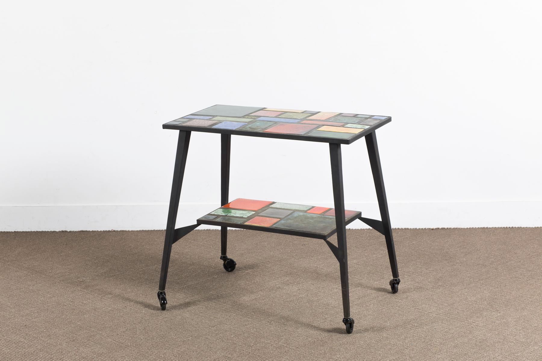Null Circa 1950 

Table on wheels with 2 ceramic tops in polychrome enamels. Met&hellip;