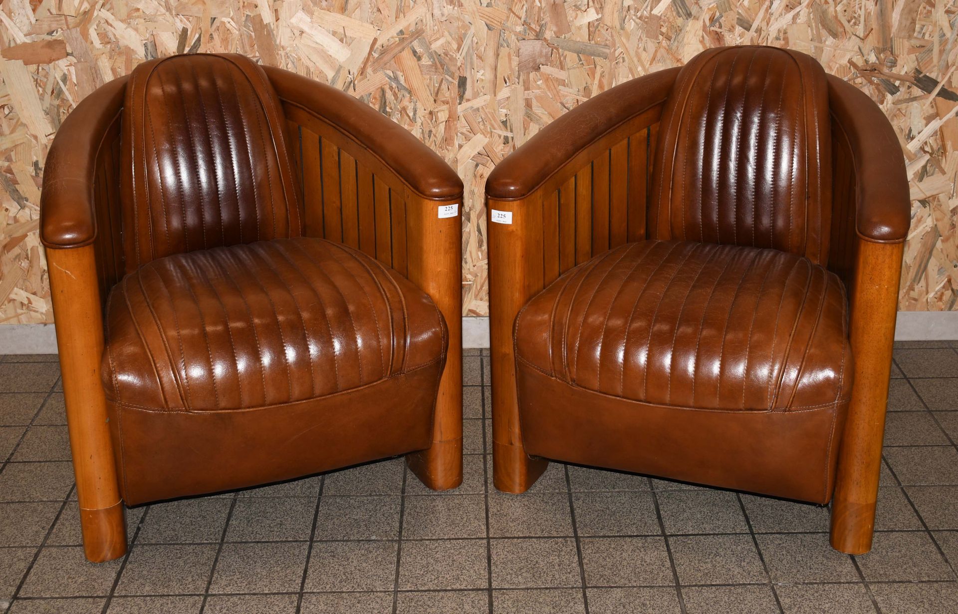 Null After Ron Arad

Pair of club chairs "aviator" in teak and brown leather.