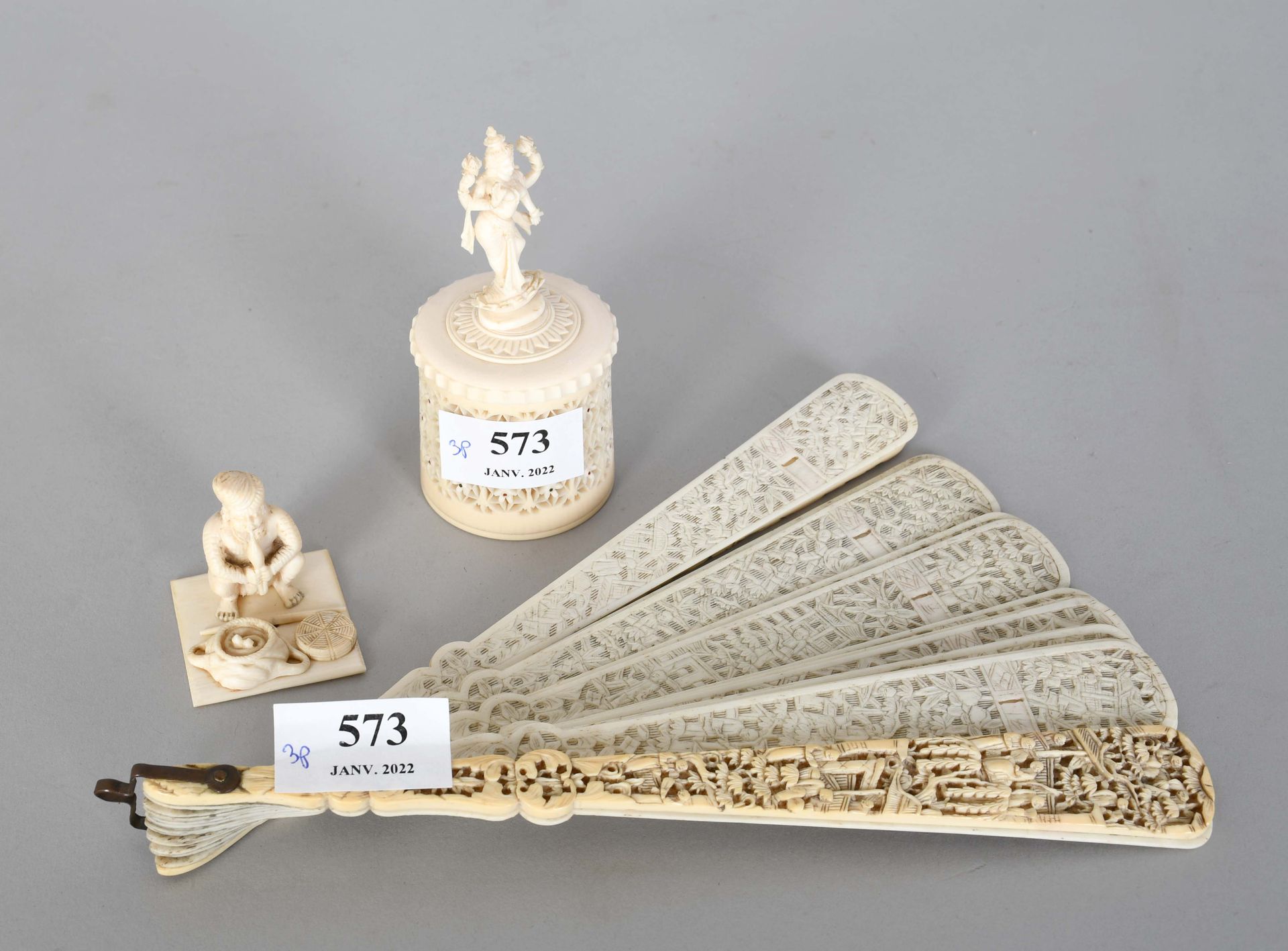Null A finely carved openwork ivory fan, an openwork box, and an ivory snake cha&hellip;