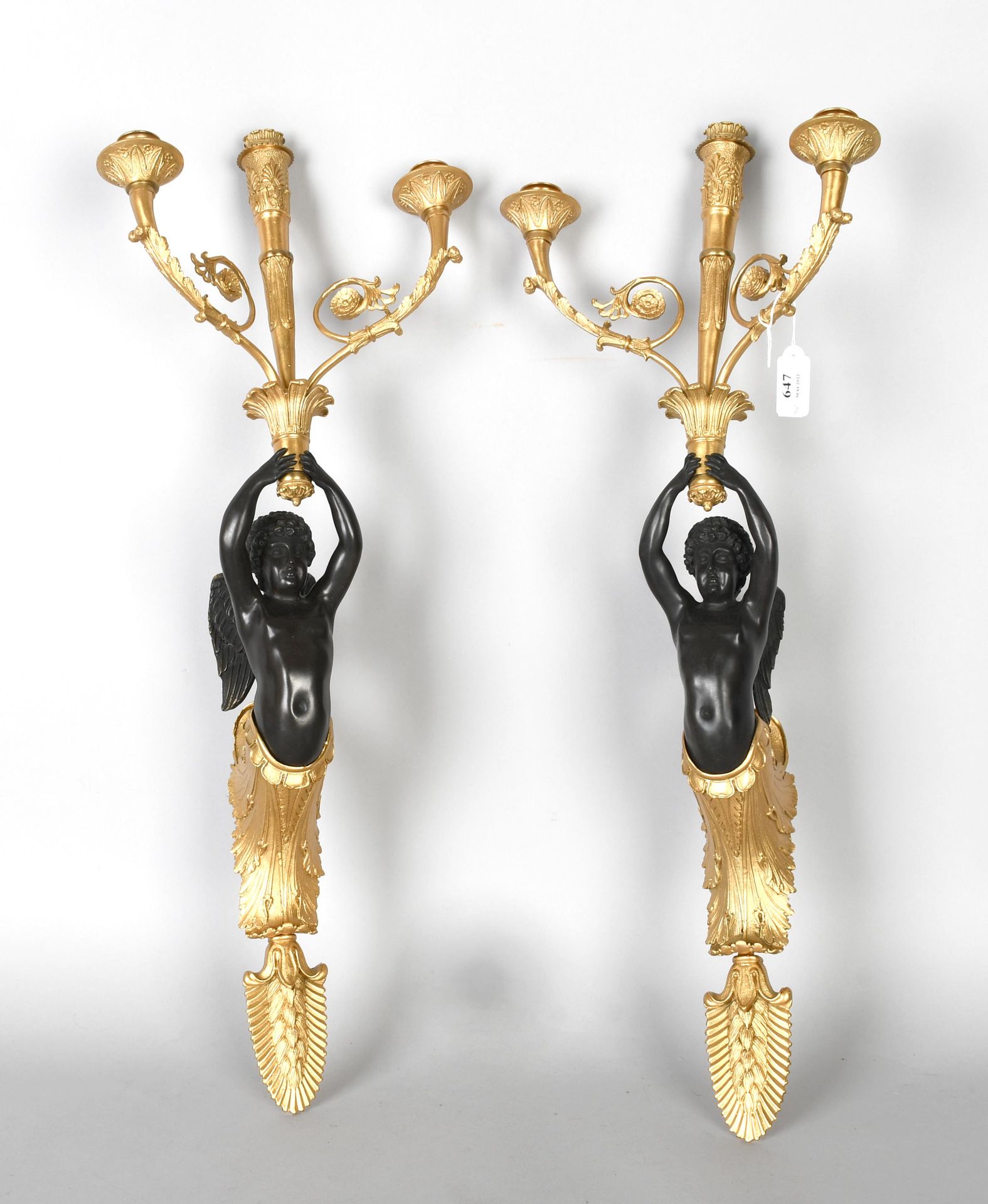 Null Pair of gilt bronze and black sconces in the Empire style, with three arms
&hellip;