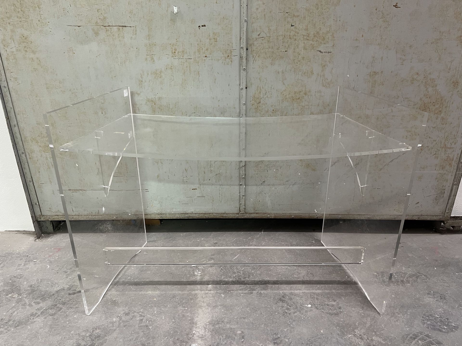 Null Desk 
Plexiglas, curved top, straight uprights joined by a brace
Work from &hellip;
