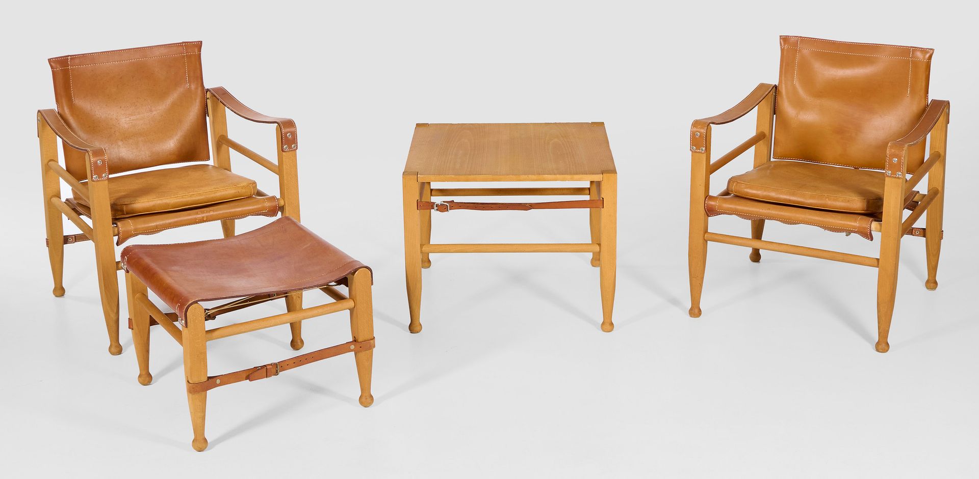 Null Aage Bruun & Søn 设计的 "Safari "家具套装，共 4 件；一对扶手椅、凳子和桌子。榉木和浅棕色芯皮。框架由折叠式支柱和带带状扶&hellip;