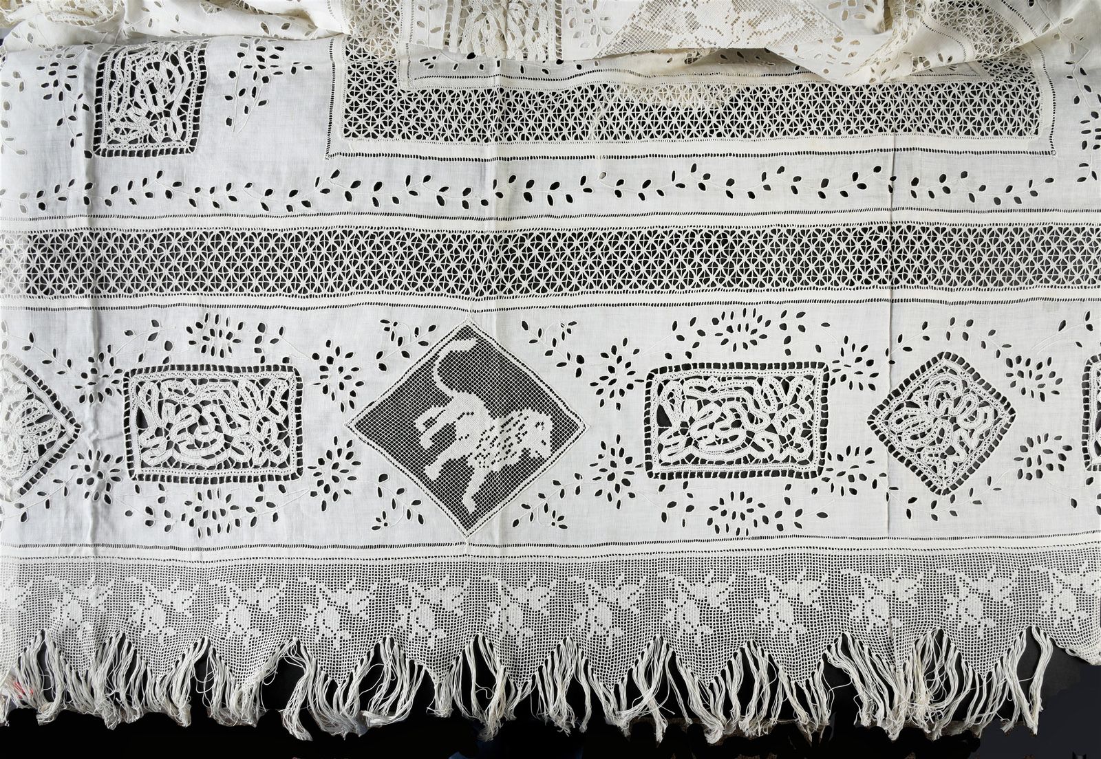 Null 绣花板，20世纪初。
绣花板上有蕾丝镶嵌和流苏，由精细的钩织边框支撑，尺寸为2.60 x 2.20米，包括流苏。(状况良好，有存放痕迹)