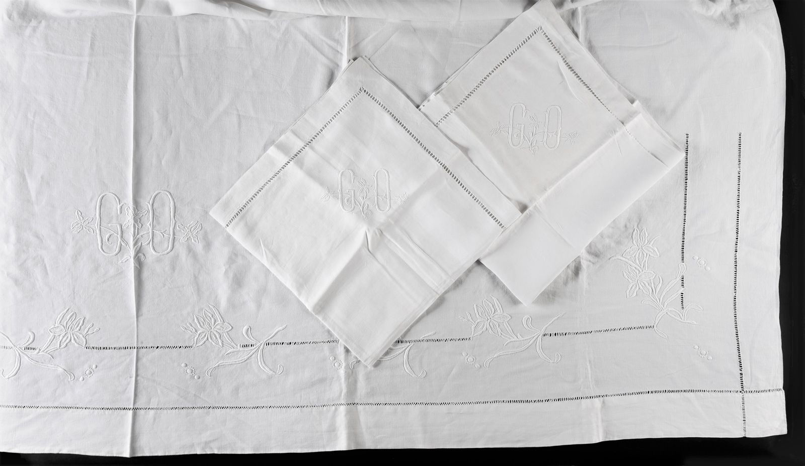 Null 
亚麻布床单和枕套，绣有百合花和天秤座，绣有GO号码。
床单宽度：2,30米（状况良好，有存放痕迹，枕套上有粉色污点）。