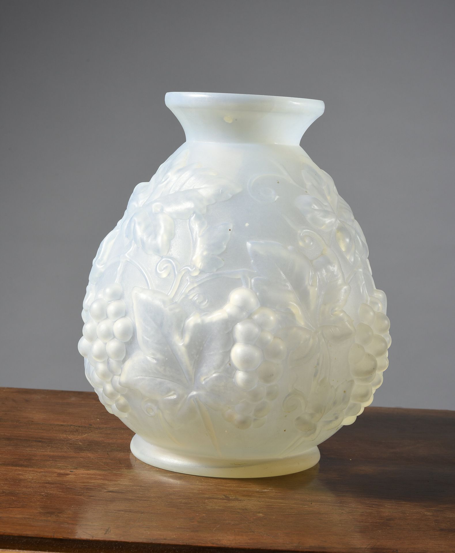 Null 乳白色模壓玻璃圓形花瓶，飾以一串葡萄。(颈部有小缺口)
高：25厘米。