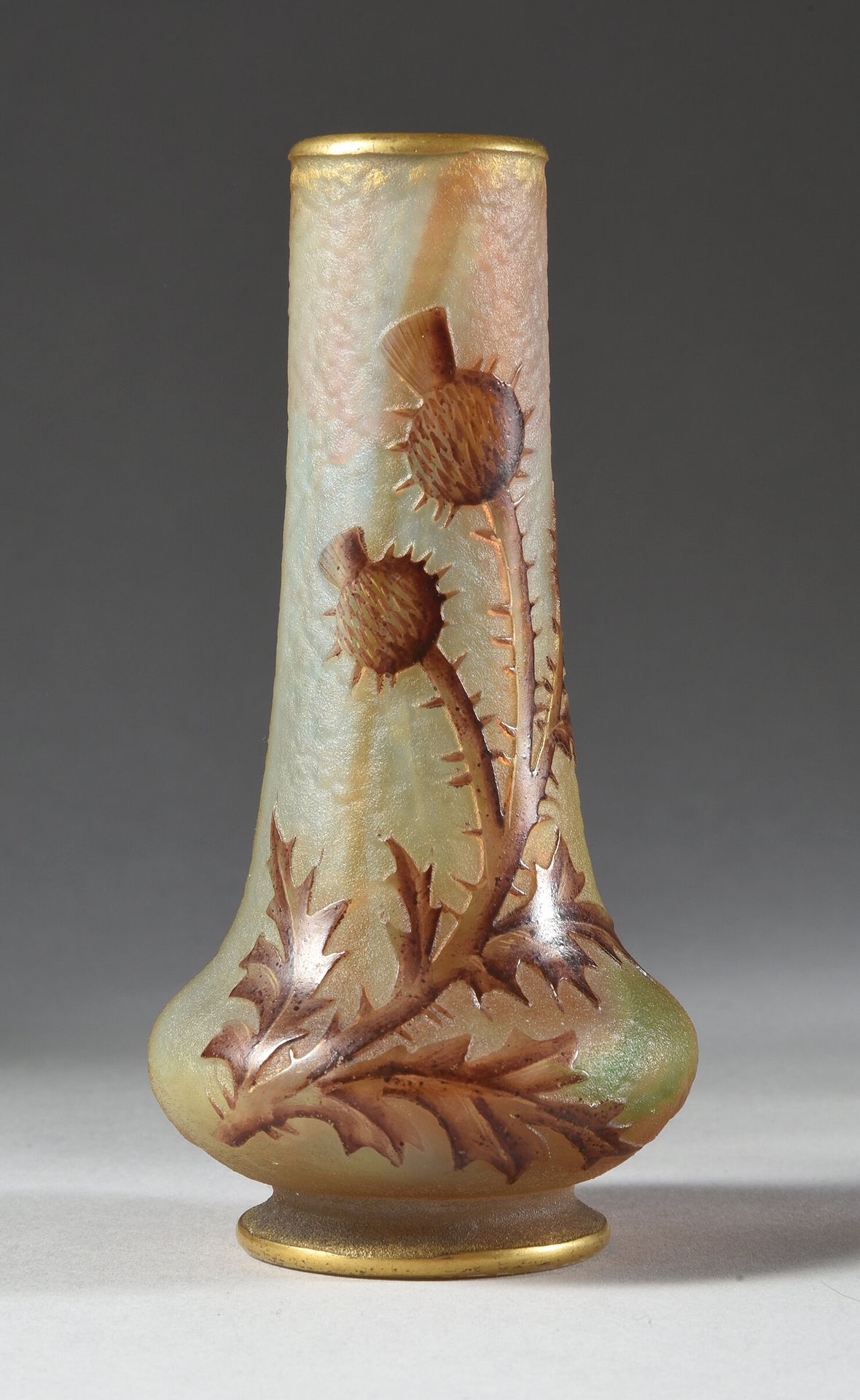 DAUM à Nancy 
脚跟上的微型花瓶。
玻璃打样，有蓟花图案。
酸蚀和多色珐琅，白、橙、绿红大理石地。
高：11.5厘米。