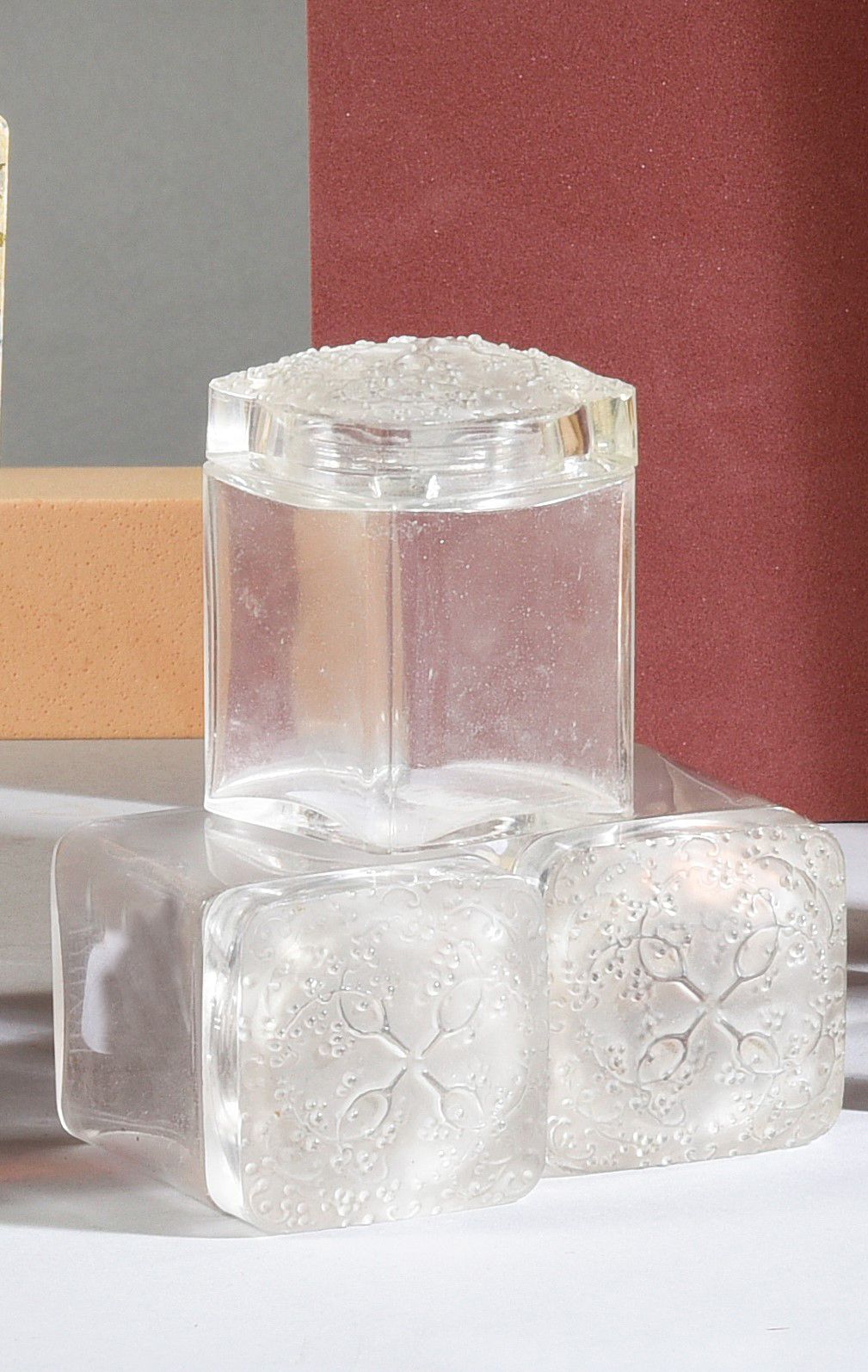 COTY - (années 1920) 
三个无色玻璃压制的立体光亮瓶，截面和形状为立方体，其磨砂玻璃盖上有模压的浆果和叶子装饰。
模型由René Laliq&hellip;