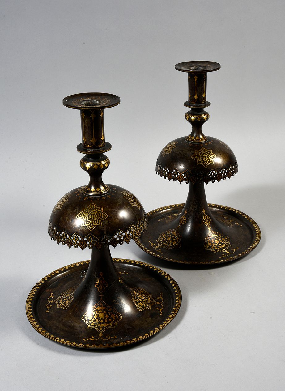 Null 一对以纳塞丁-沙阿为名的卡扎尔烛台
镶嵌黄金的钢制烛台
伊朗，19世纪，卡扎尔时期
高度29厘米
根据穆罕默德-霍拉姆基什先生的疯狂拍卖成交。