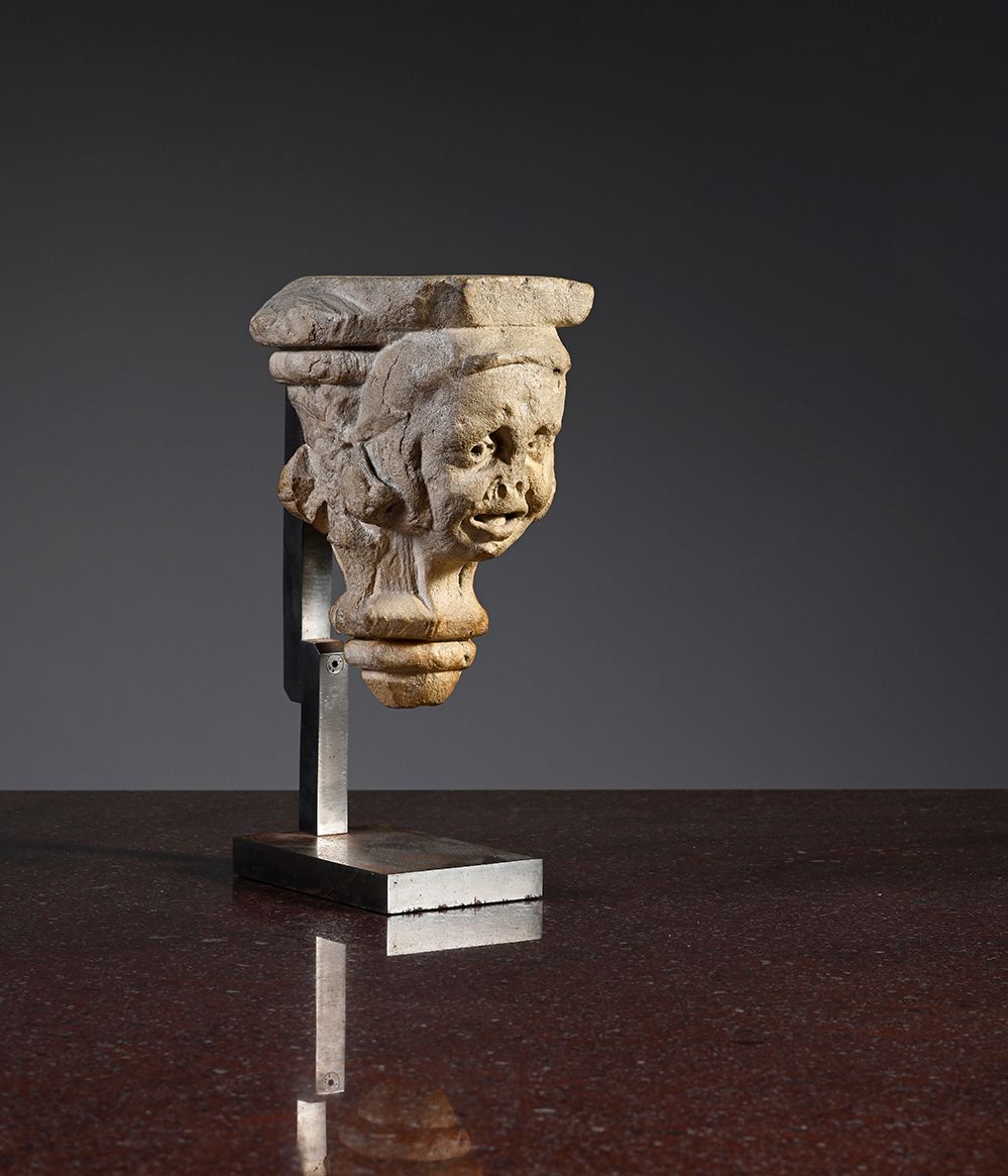 Null Limestone base carved with a grinning head, round face, pierced eyes, open &hellip;