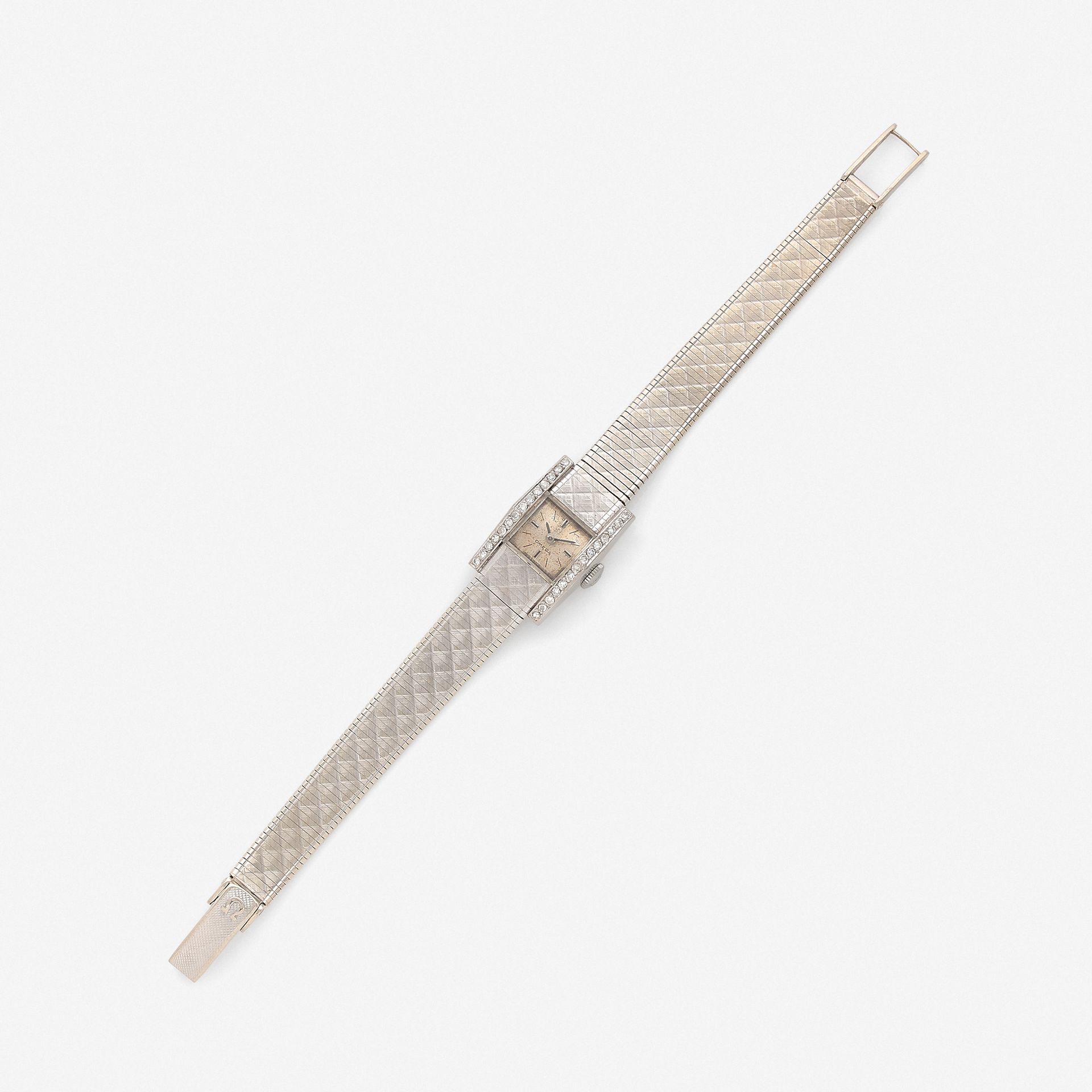 Null 欧米茄

 约1960年

女士全白金珠宝表款 银色表盘、刻度和指挥棒指针

表圈上镶嵌着两行钻石

五线谱机械机芯

尺寸：15 x 23 mm

&hellip;