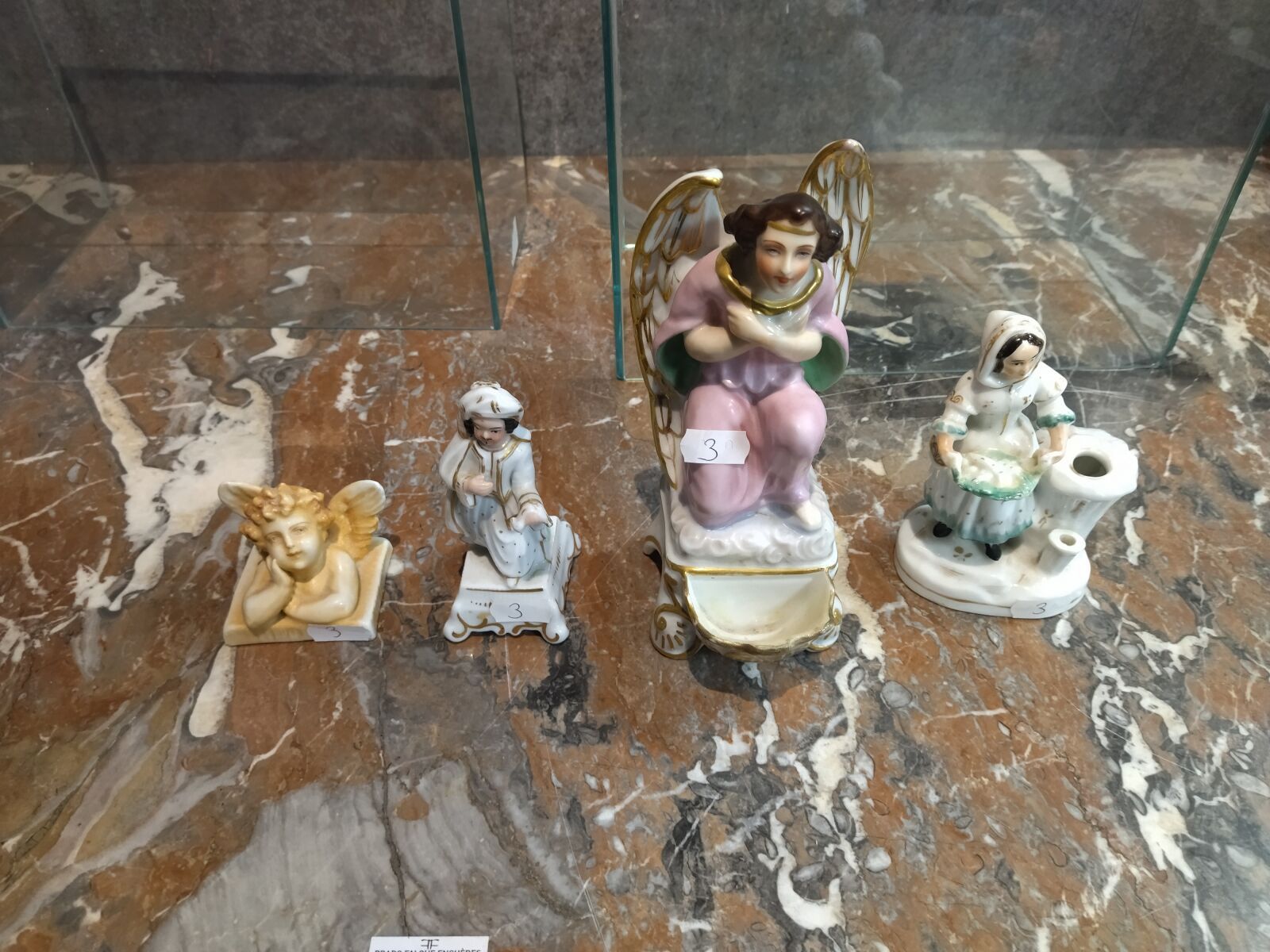 Null Reunion of four enameled porcelain subjects: an angel forming a stoup (rest&hellip;