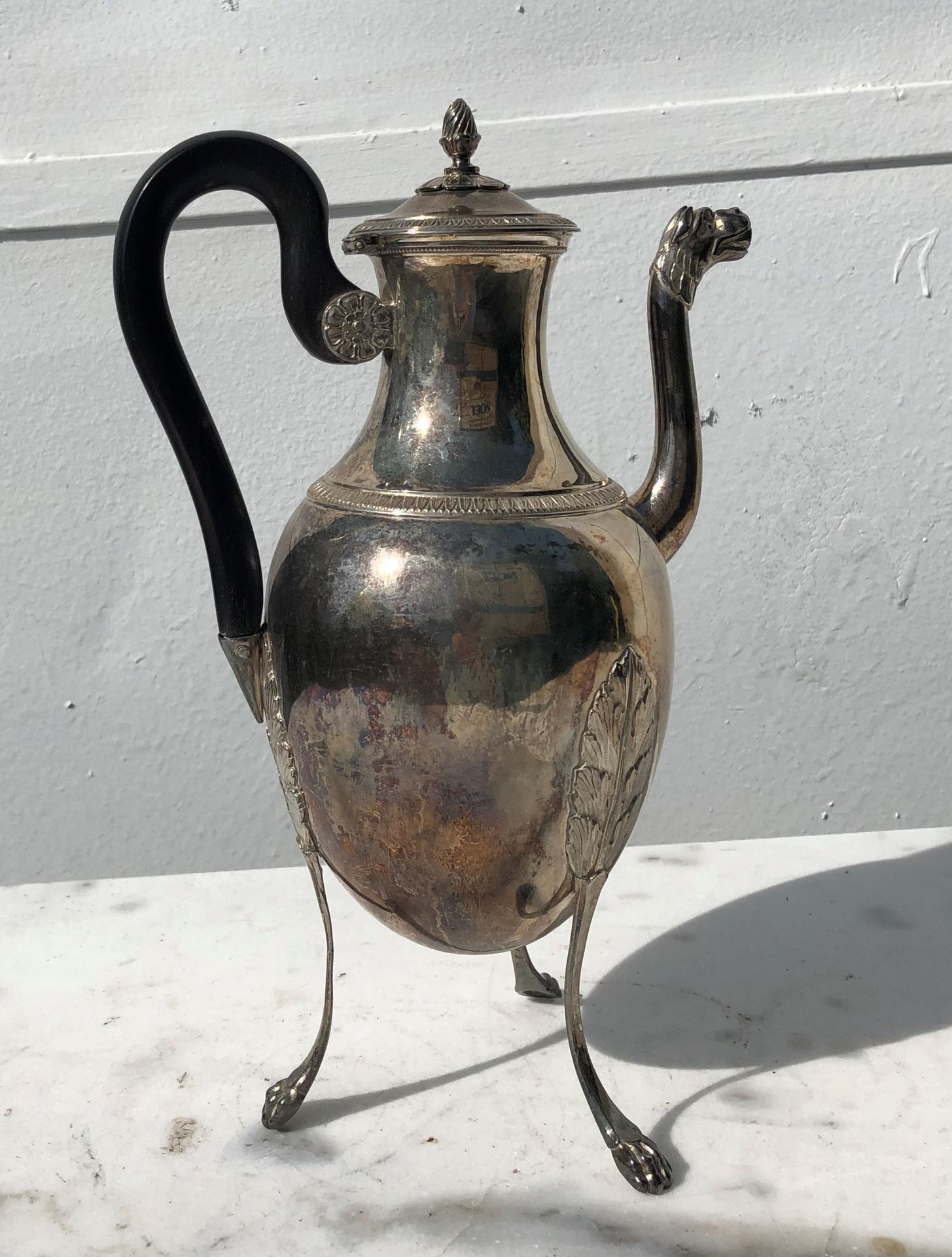 Null Silver tripod teapot, blackened wood handle, claw feet. 19th century.

Wear&hellip;