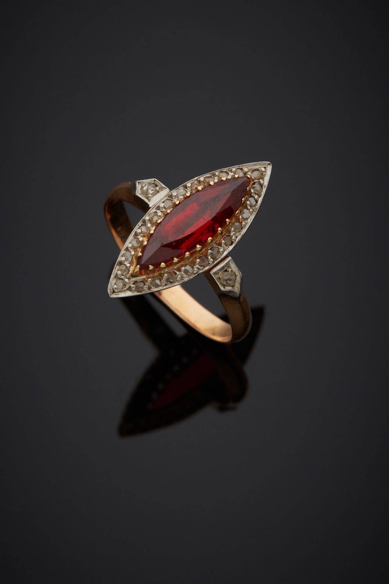 Null 750‰的双色18K金榄尖形戒指，在玫瑰式切割钻石的环绕中镶嵌了一颗红色宝石。

手指大小54，毛重3克