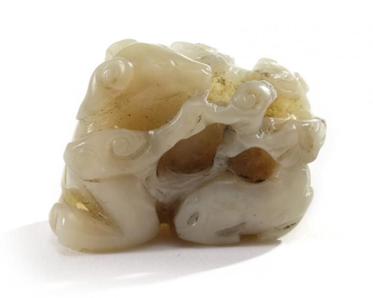 A Chinese celadon jade 'dogs' group The piece is carved and pierced in the round&hellip;