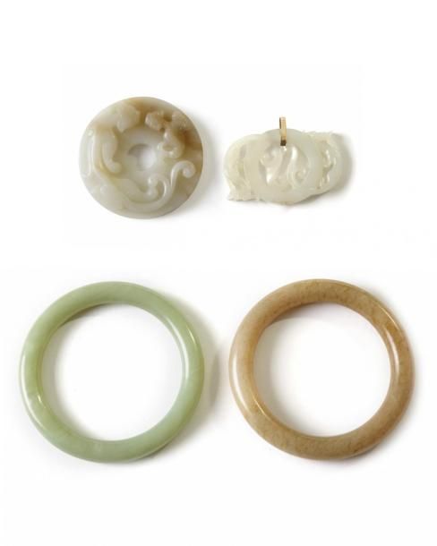 Four Chinese jade carvings The first is a pale celadon and russet jade 'chilong'&hellip;