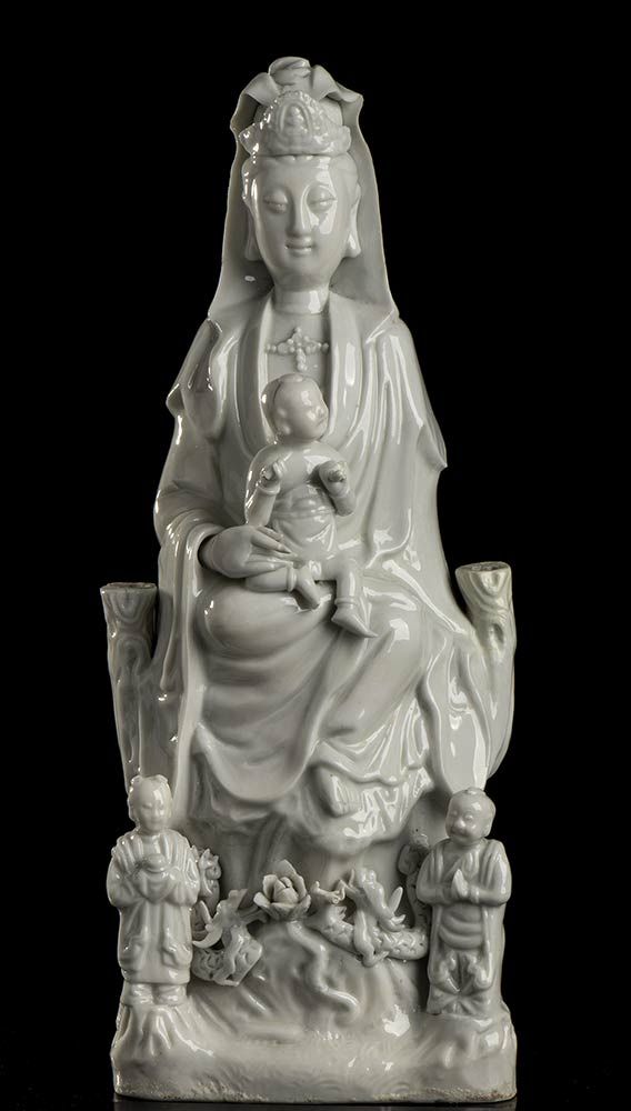 A 'BLANC DE CHINE' PORCELAIN GUANYIN ON THRONE WITH CHILD AND ATTENDANTS GUANYIN&hellip;