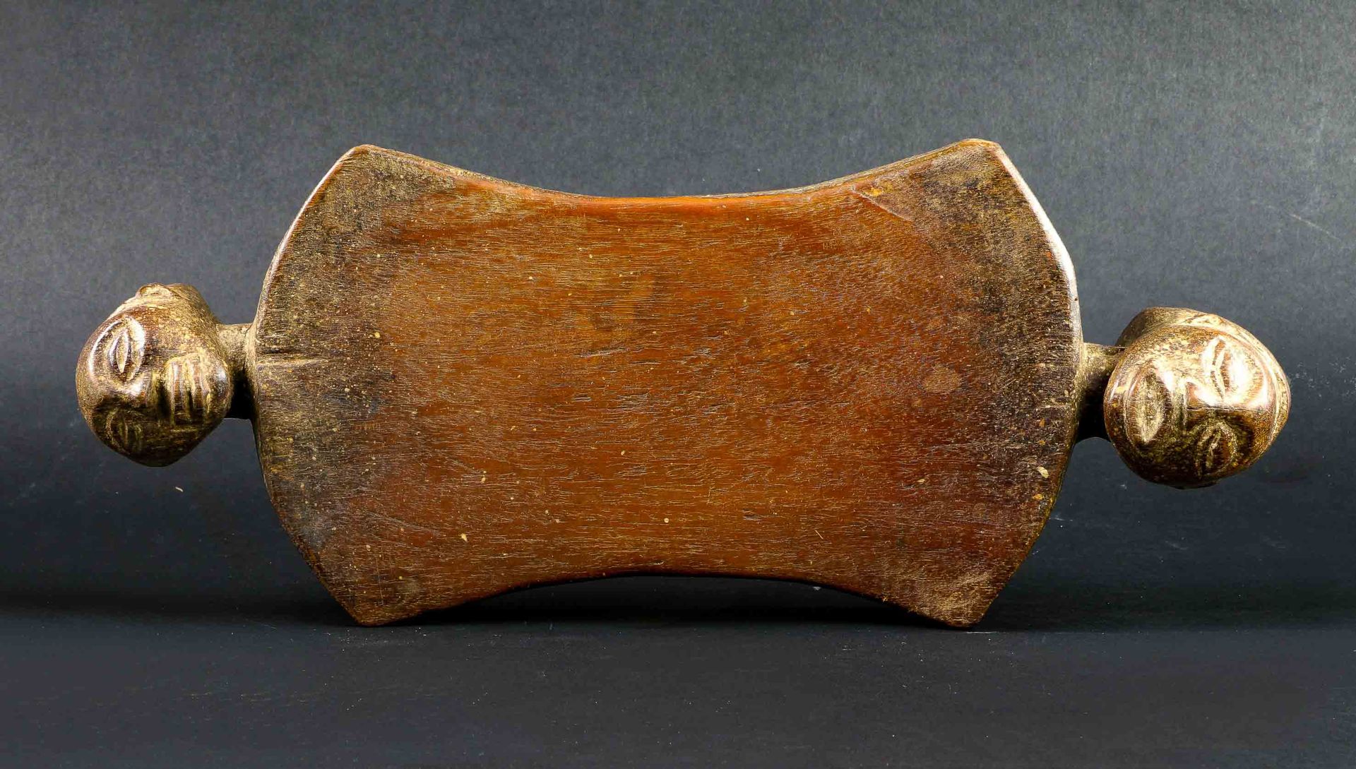 Null Wooden headrest with old patina and marks of use. It is carved at each end &hellip;