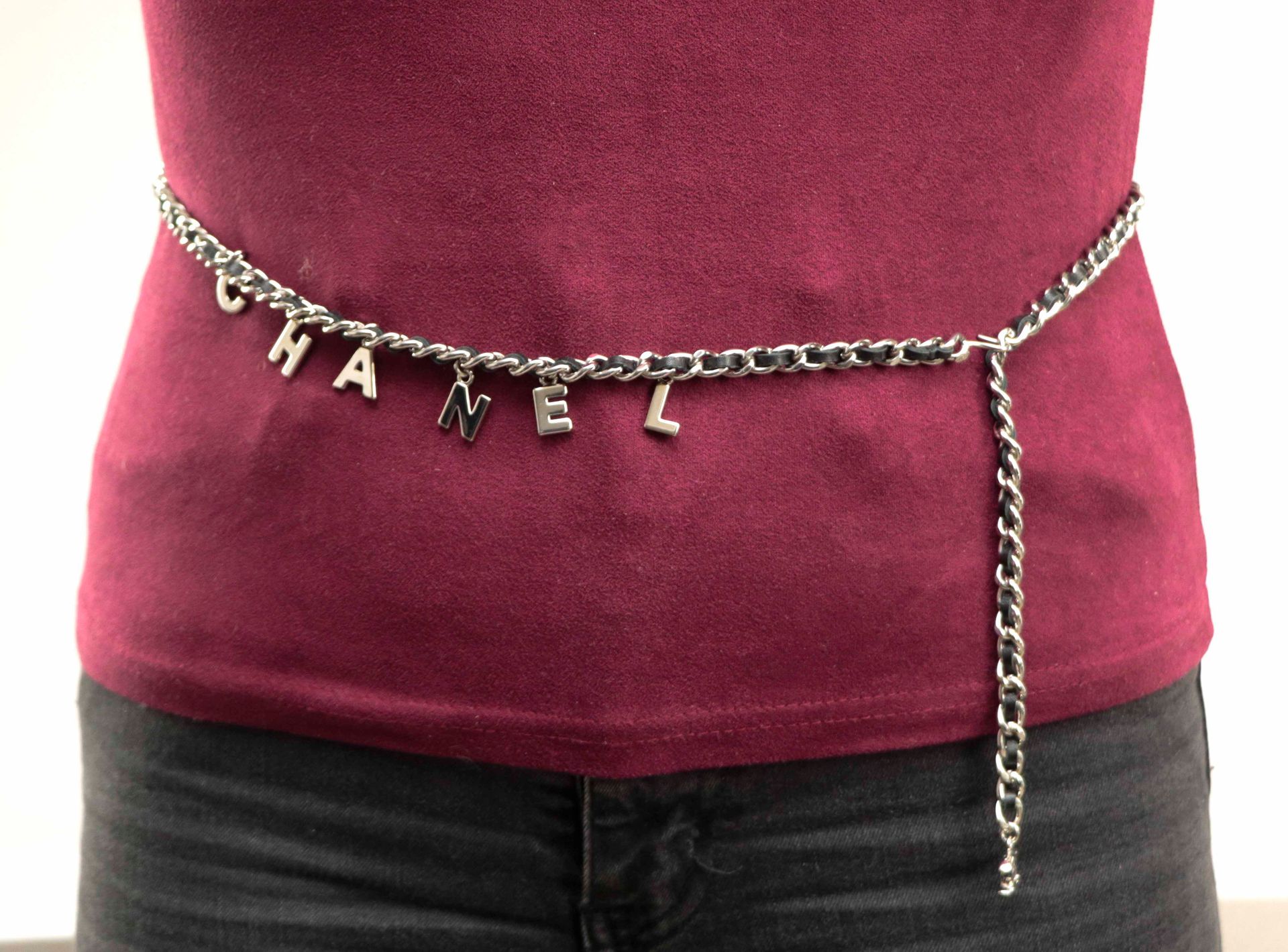Null 香奈儿。镀银金属腰带或链条，与黑色皮革交错，装饰有字母组成的香奈儿品牌的流苏。长：91厘米