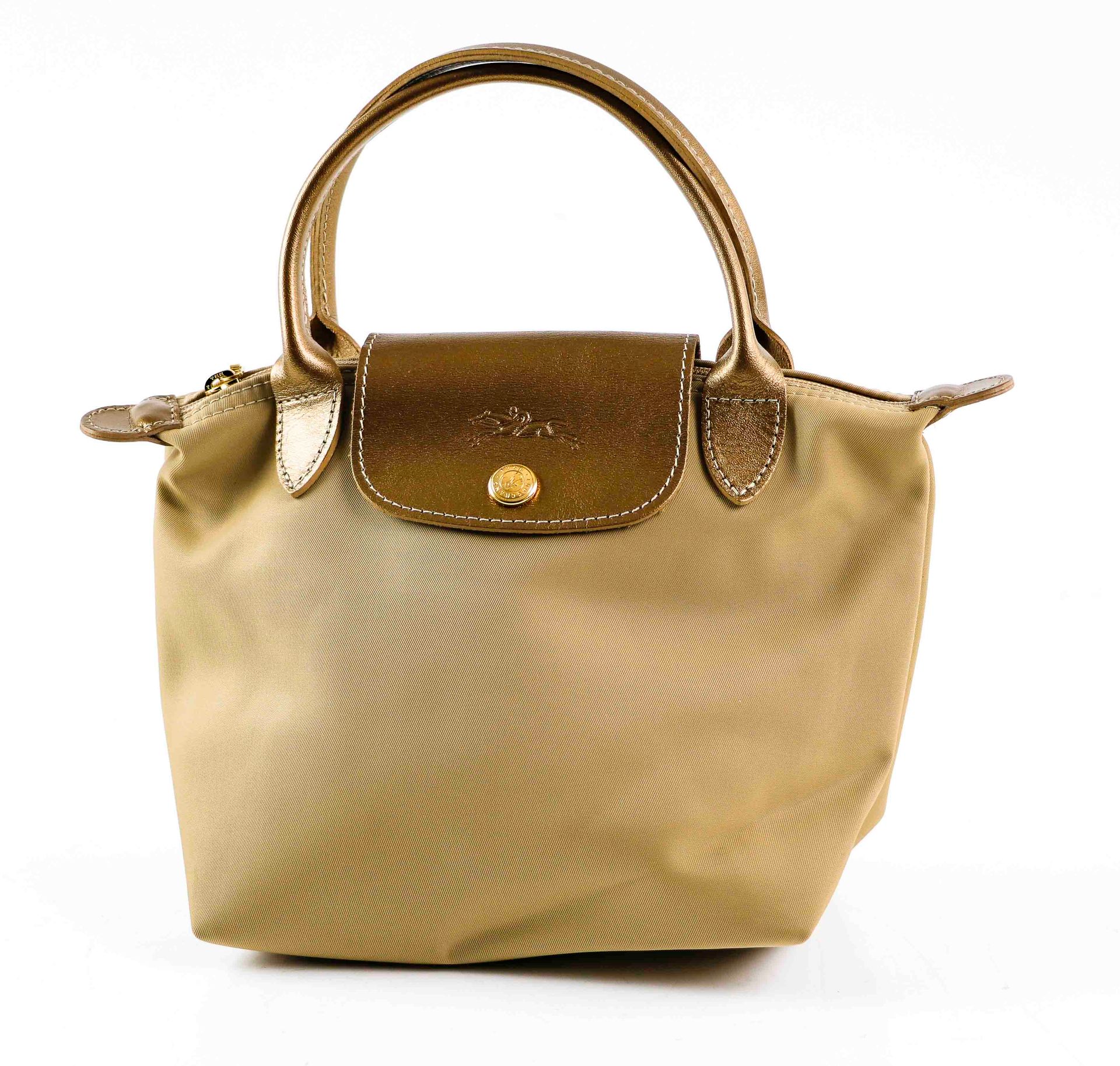 Null LONGCHAMP. Folding bag in beige canvas and golden leather. Double handle