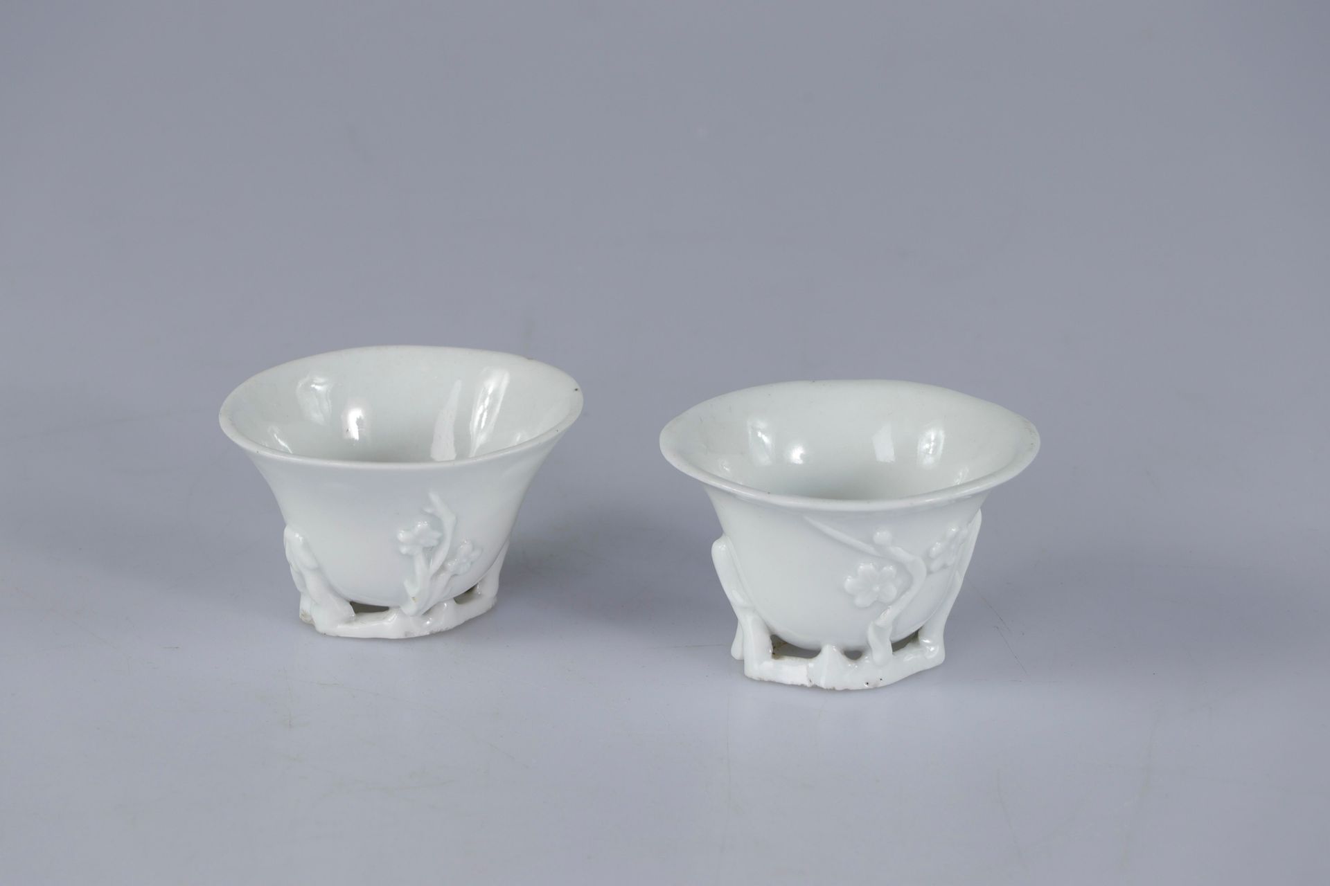 Null (2) 中国，康熙时期。一对德化瓷器酹酒杯，称为 "玉兰杯"，小脚，浮雕梅花和玉兰花枝盛开，脚采取镂空的形式。尺寸：最宽处8.5厘米（每个）
出处：私&hellip;