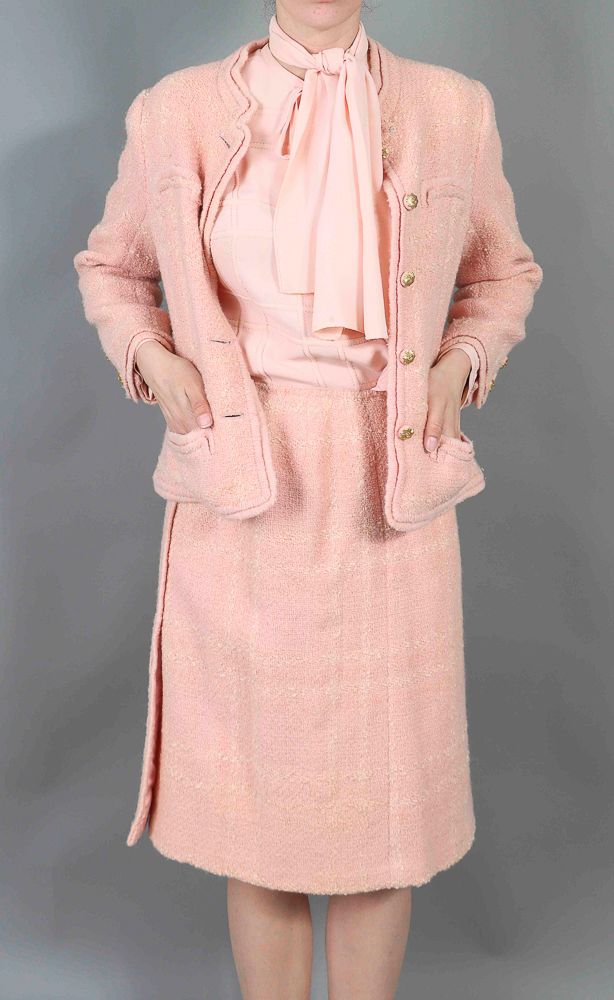CHANEL. Candy pink wool tweed suit including a jacket, a…